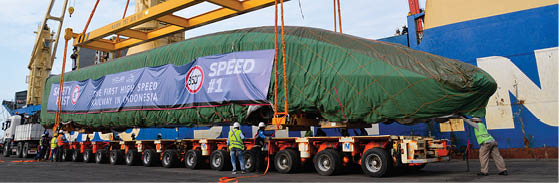 (220902) -- JAKARTA, Sept. 2, 2022 (Xinhua) -- Photo taken on Sept. 2, 2022 shows a high-speed electric passenger train, customized for the Jakarta-Bandung high-speed railway, being unloaded from a vessel in Tanjung Priok Port in Jakarta, Indonesia. A high-speed electric passenger train and an inspection train, made in China and customized for the Jakarta-Bandung High-Speed Railway (HSR) project, arrived in the Jakarta Port from China's Qingdao Port on Thursday.   The arrival of the trains symbolizes another milestone for the construction of the Jakarta-Bandung HSR. It was also the first time that high-speed trains made in China were exported to another country. (Xinhua/Xu Qin)
